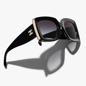 CHANEL Black and Gold Sunglasses with Bold Design